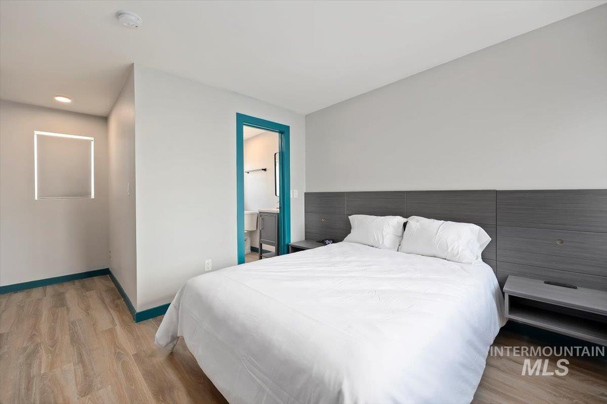 Bedroom with wood finished floors and recessed lighting