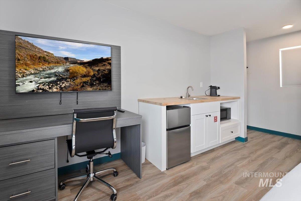 Office with a sink and light wood finished floors