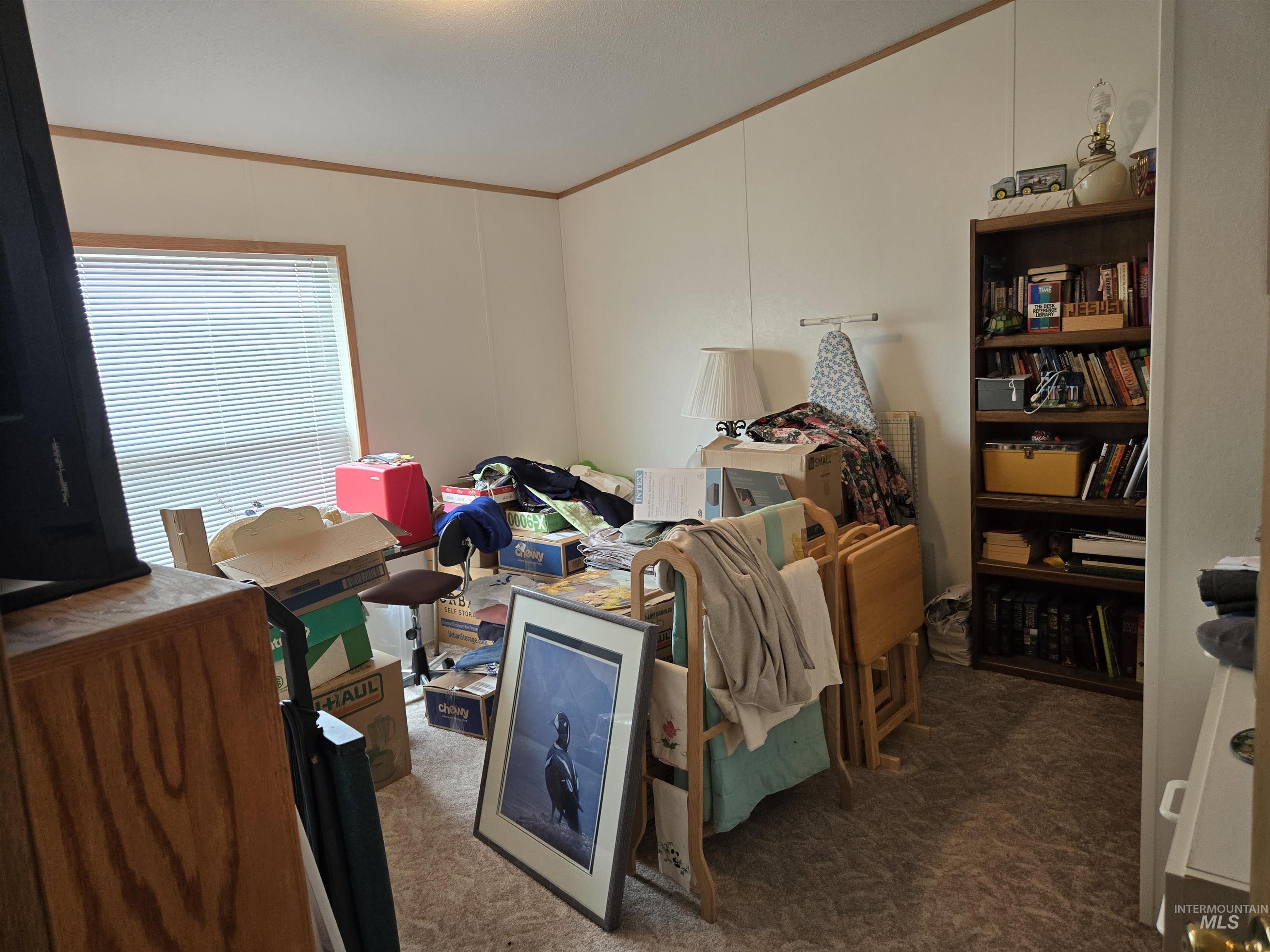 Carpeted bedroom featuring crown molding