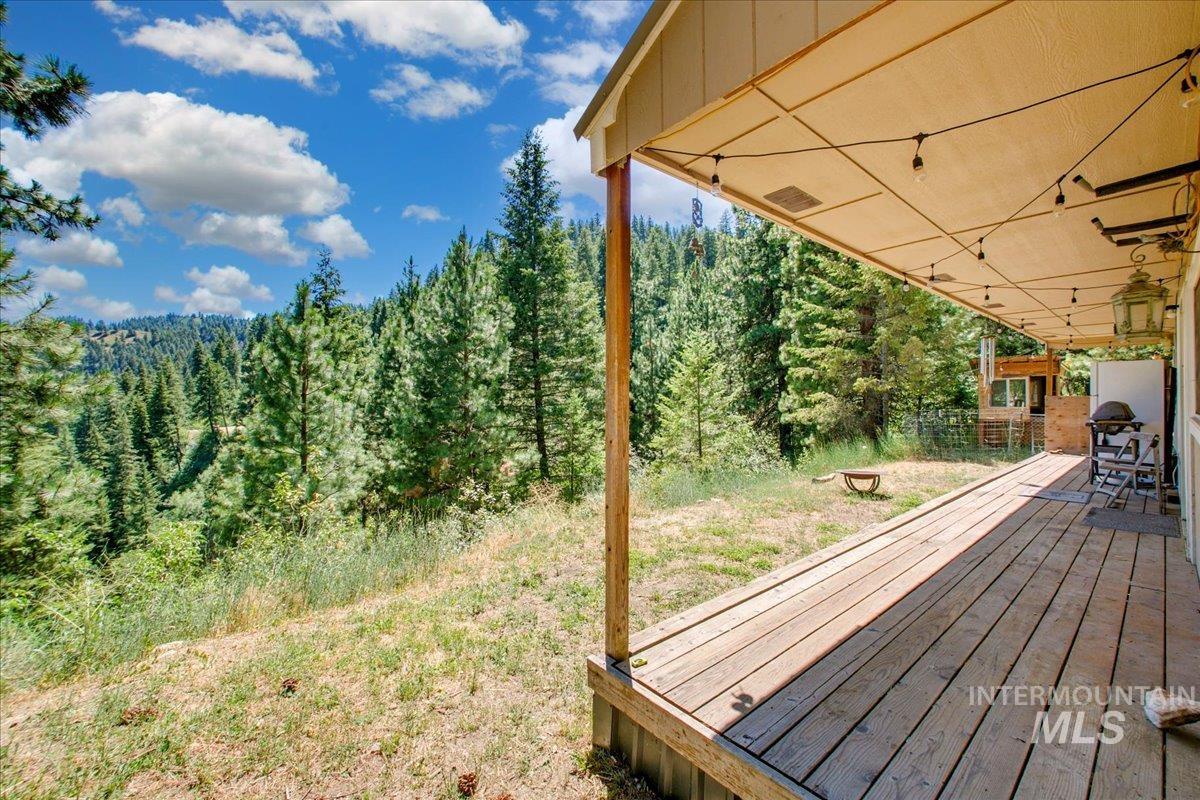 Wooden terrace featuring a view of trees