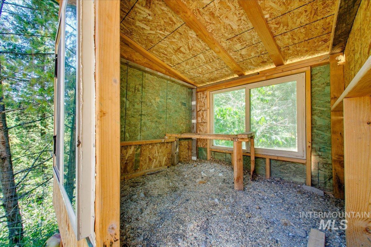 Unfurnished sunroom with lofted ceiling