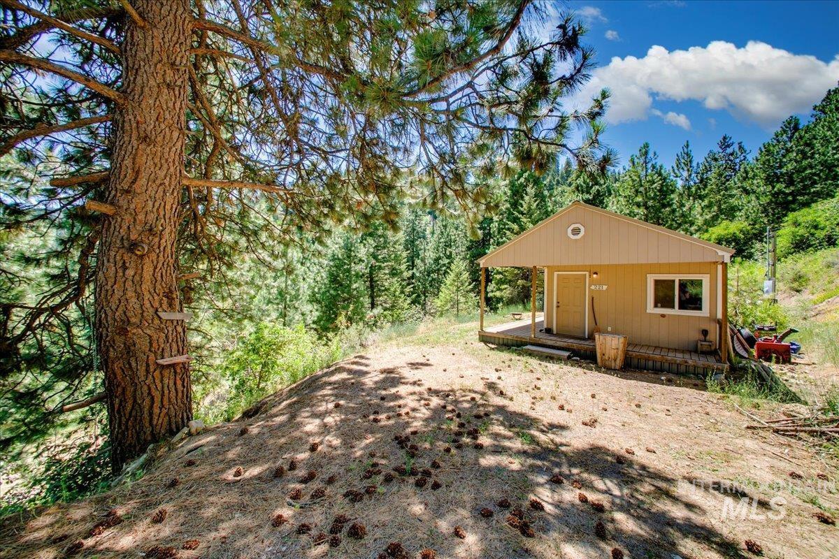 View of front of property featuring a forest view