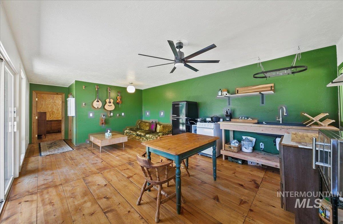 Dining area featuring light wood finished floors and a ceiling fan