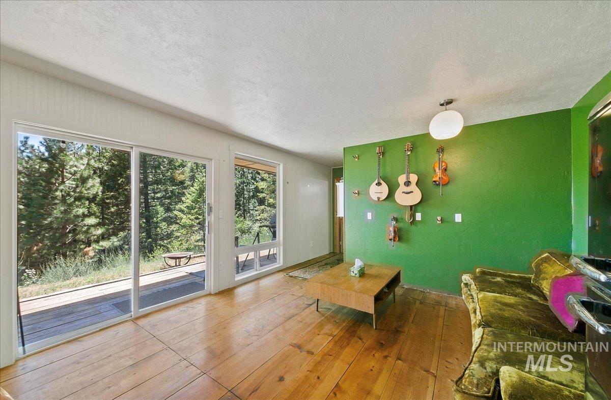 Living room featuring wood-type flooring and a textured ceiling
