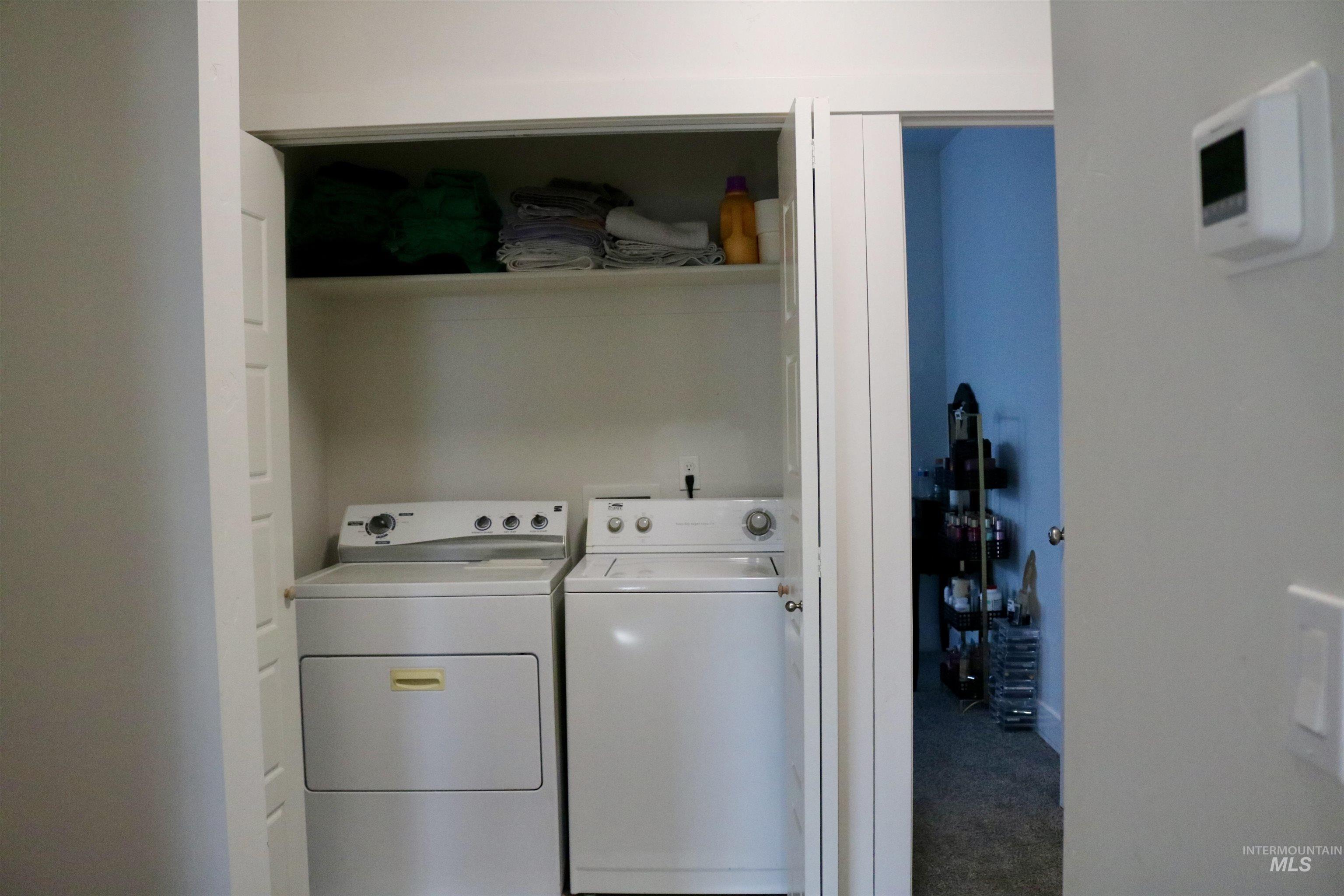 Laundry room featuring washer and clothes dryer