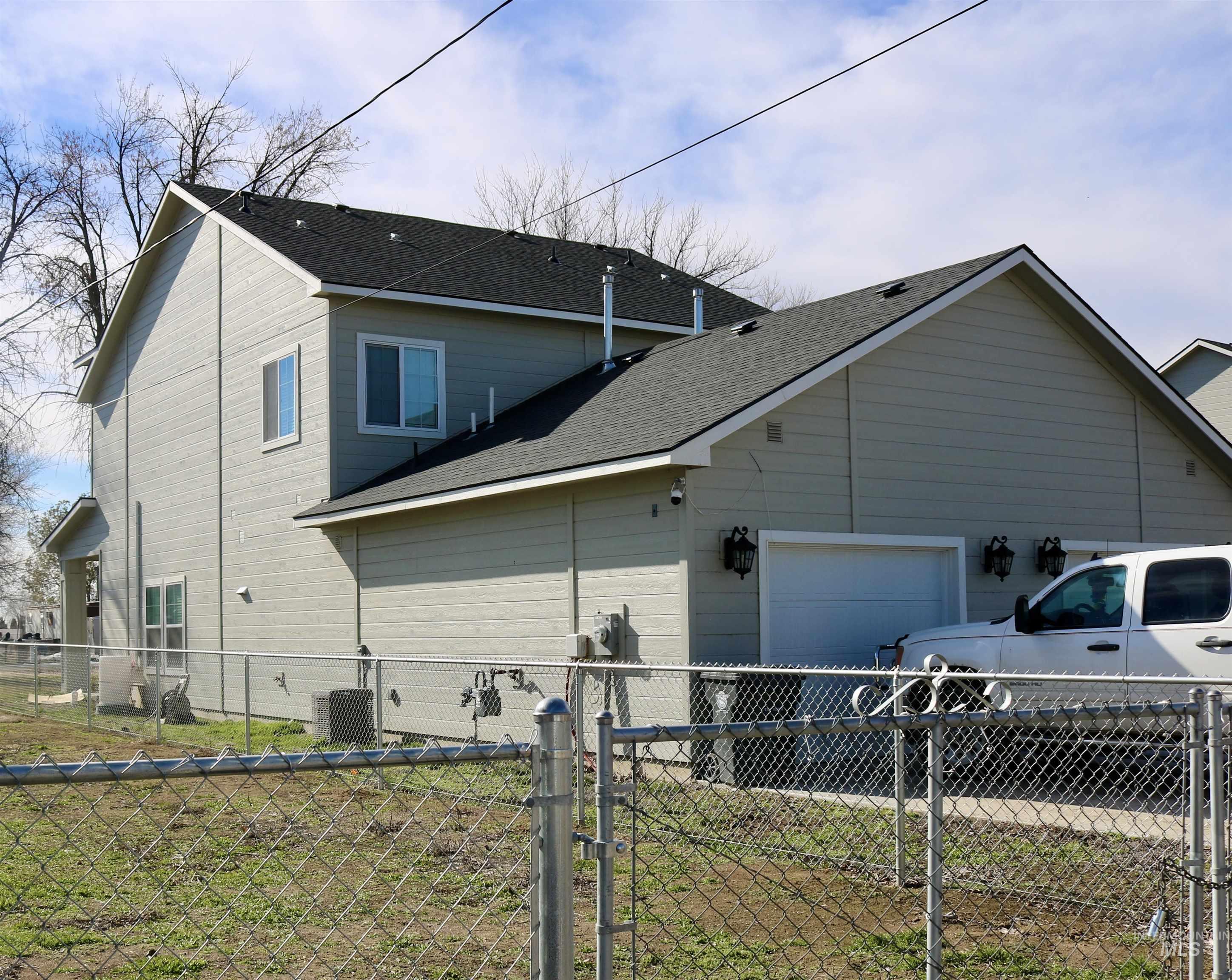 View of home\'s exterior with a garage and a shingled roof