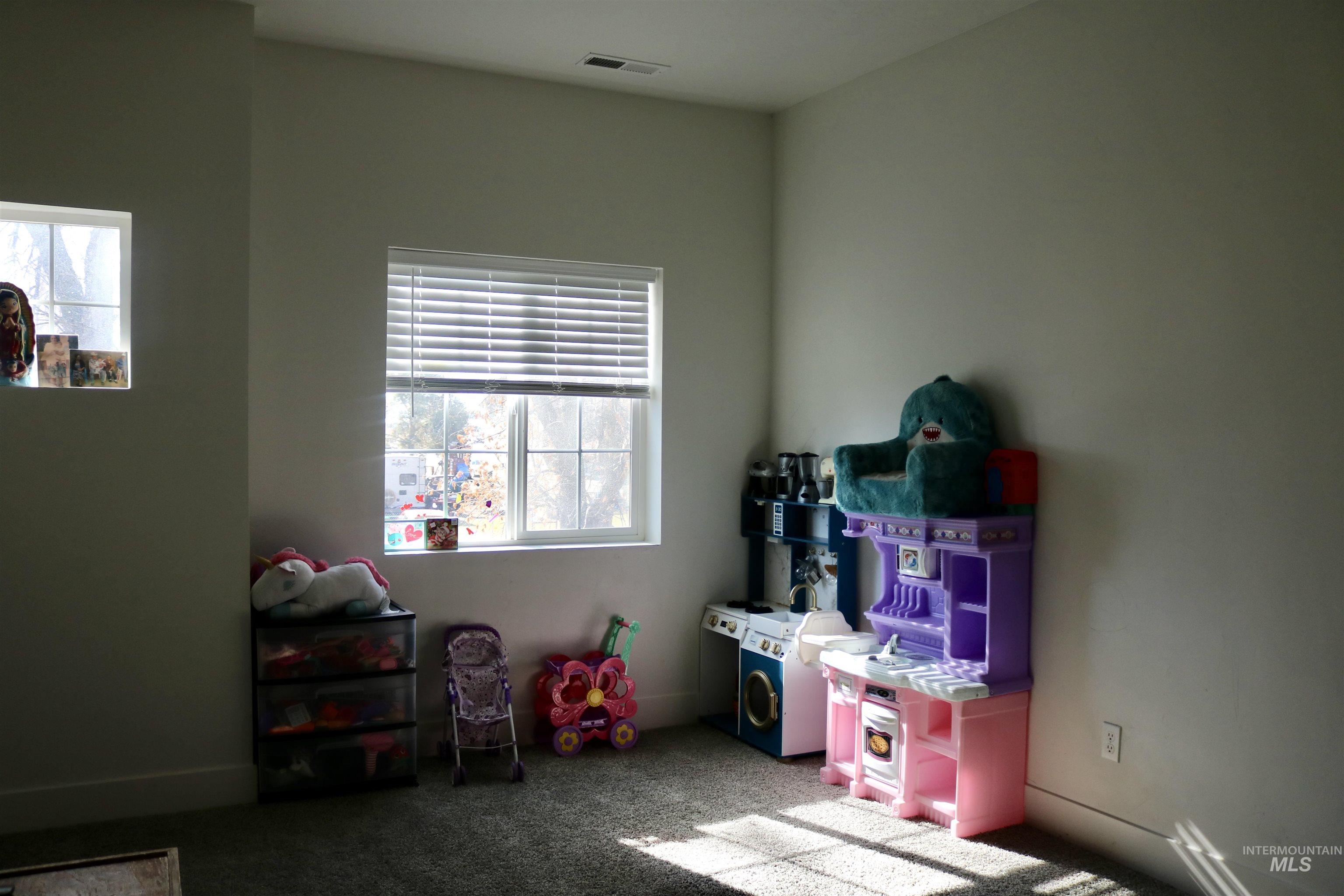 Playroom with carpet flooring