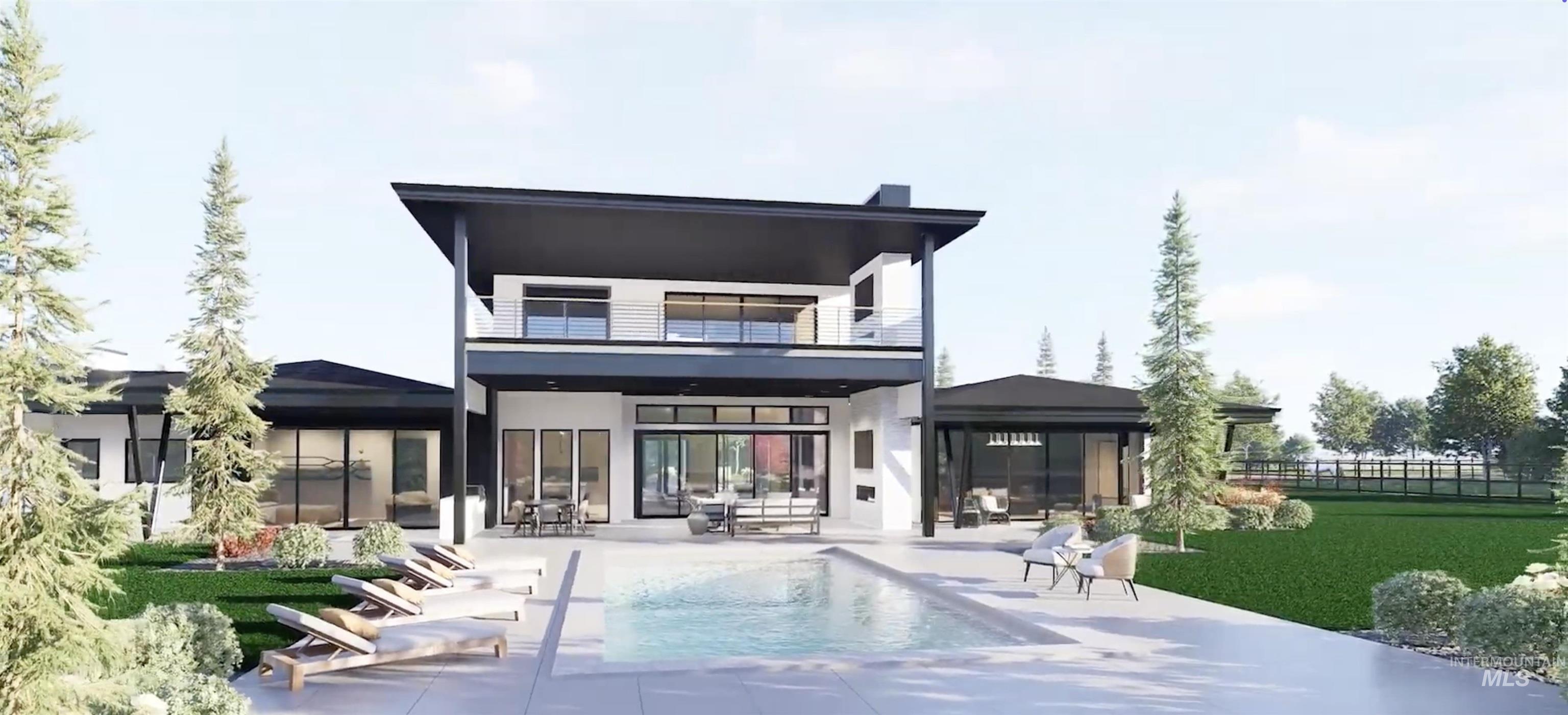 Back of property featuring a balcony, a patio, stucco siding, and an outdoor pool