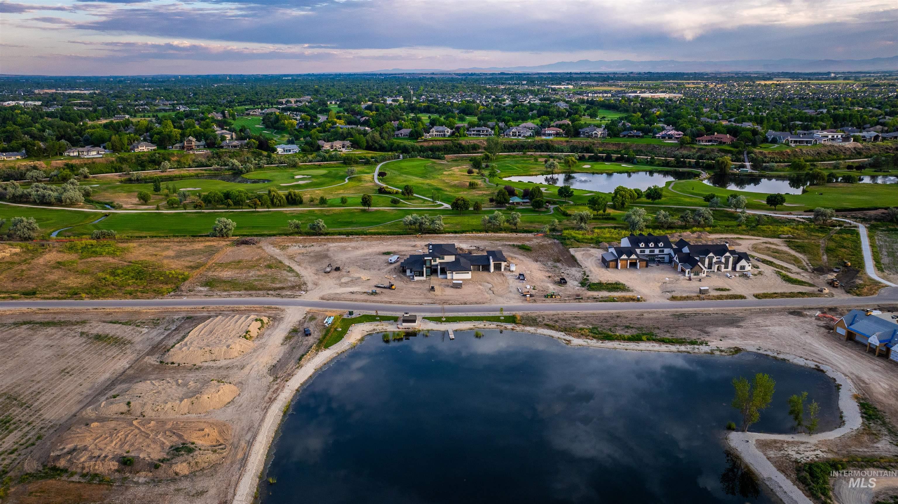 Aerial overview of property's location featuring a nearby body of water and nearby suburban area