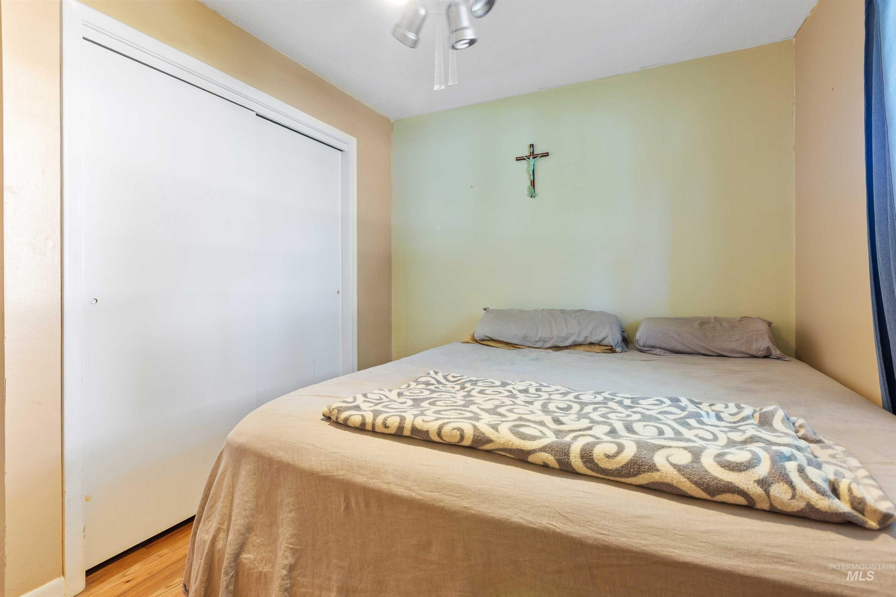 Bedroom featuring a closet and light wood-type flooring
