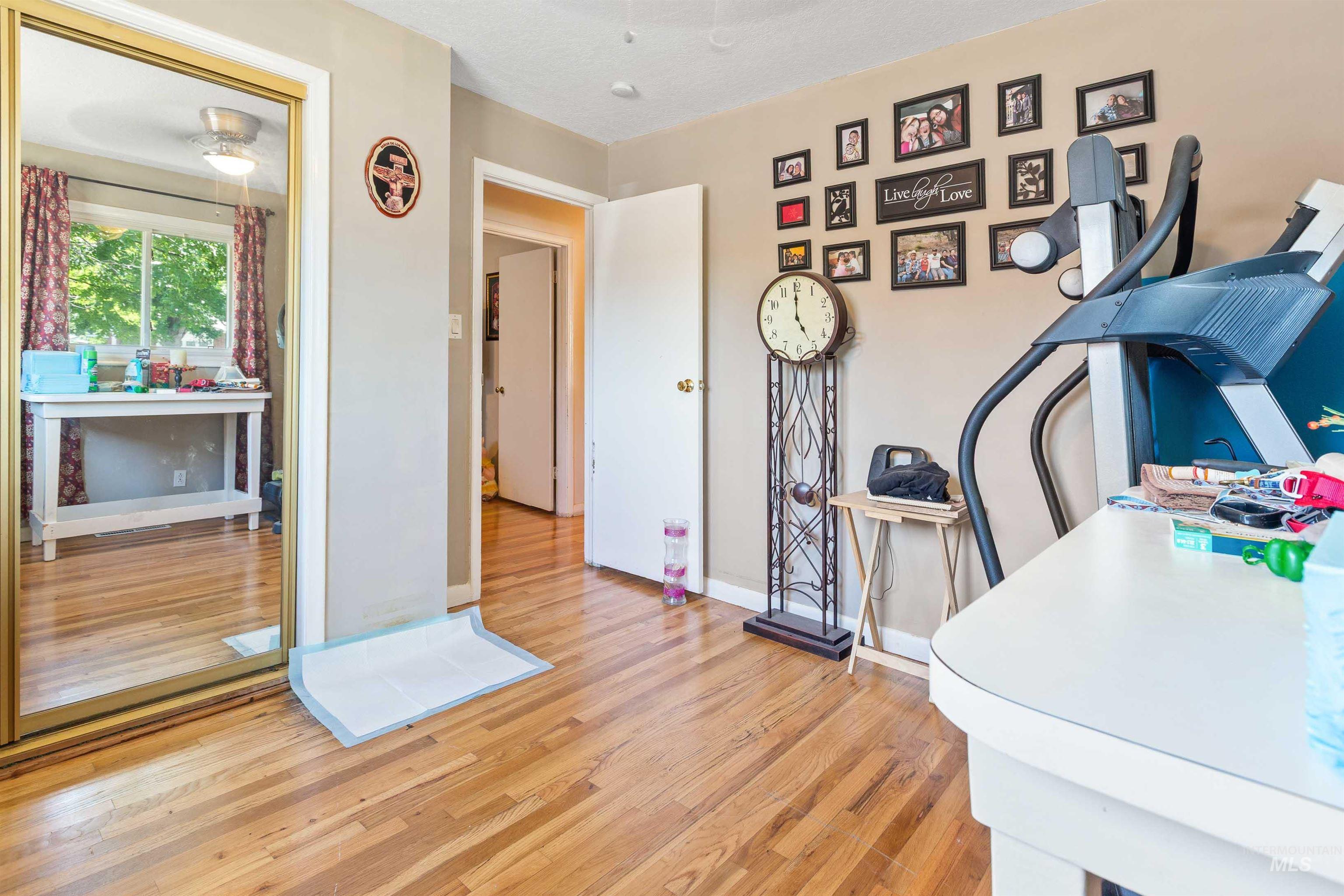 Home office with wood finished floors and baseboards