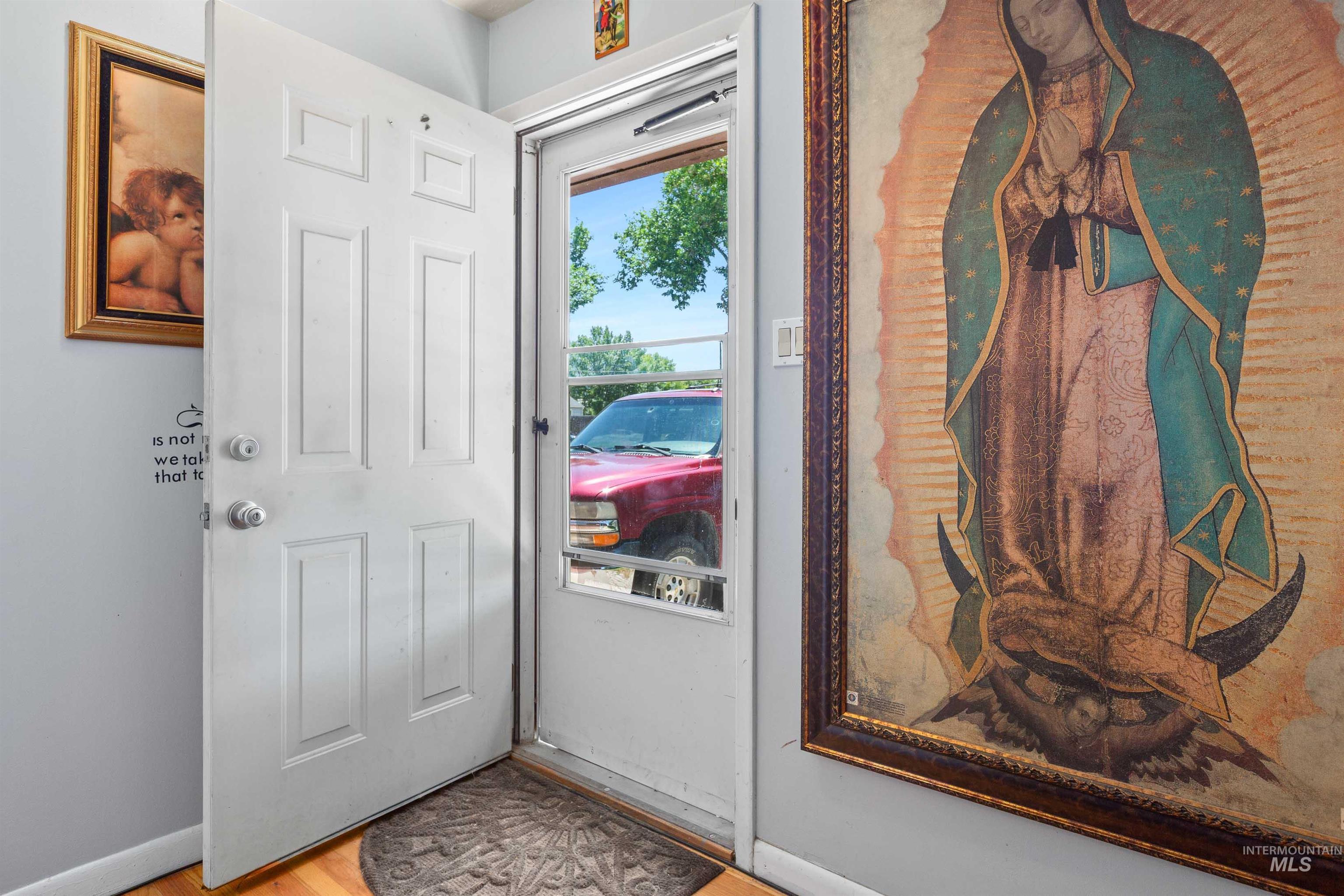Foyer entrance featuring baseboards and wood finished floors