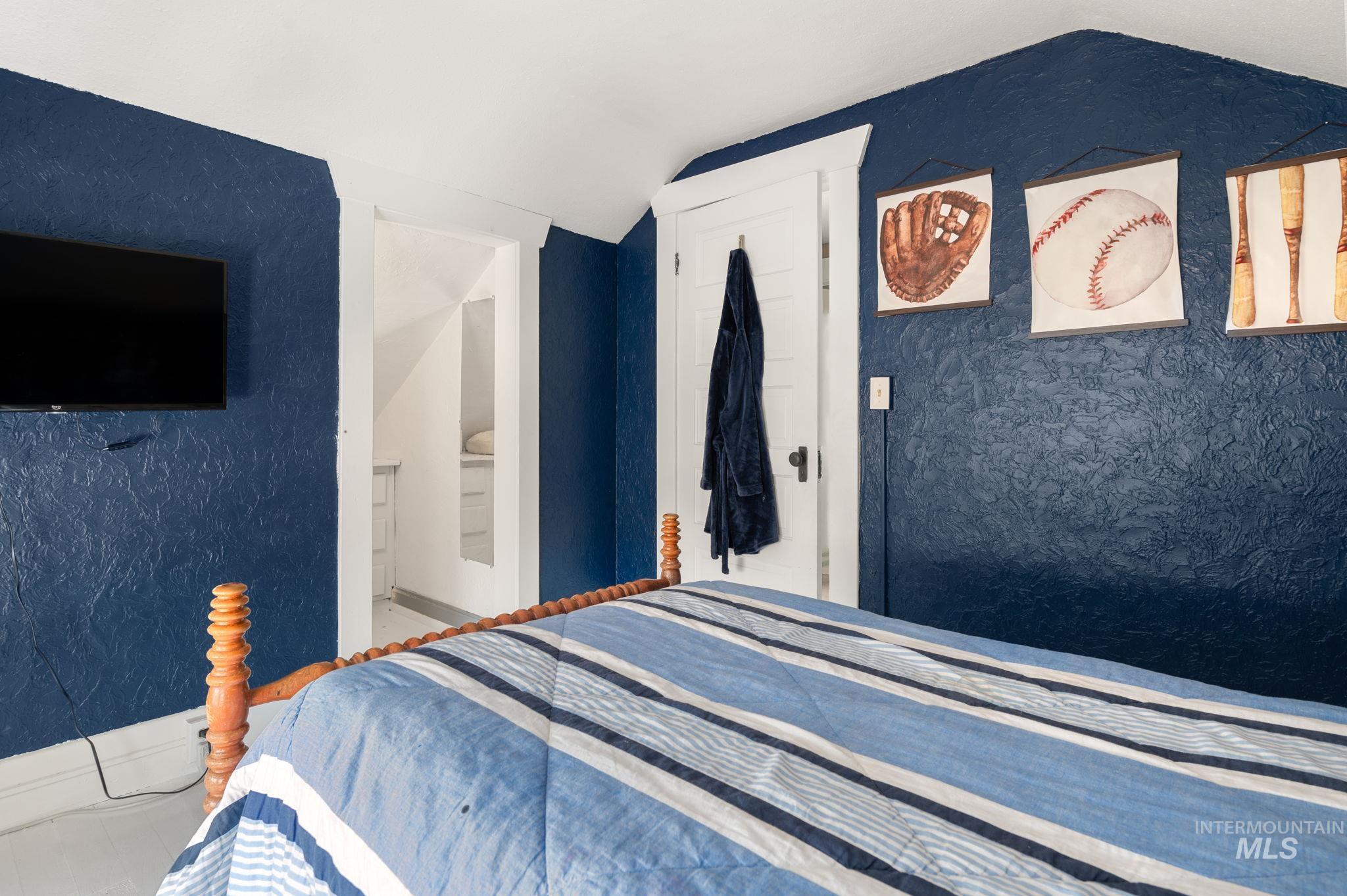 Bedroom featuring vaulted ceiling