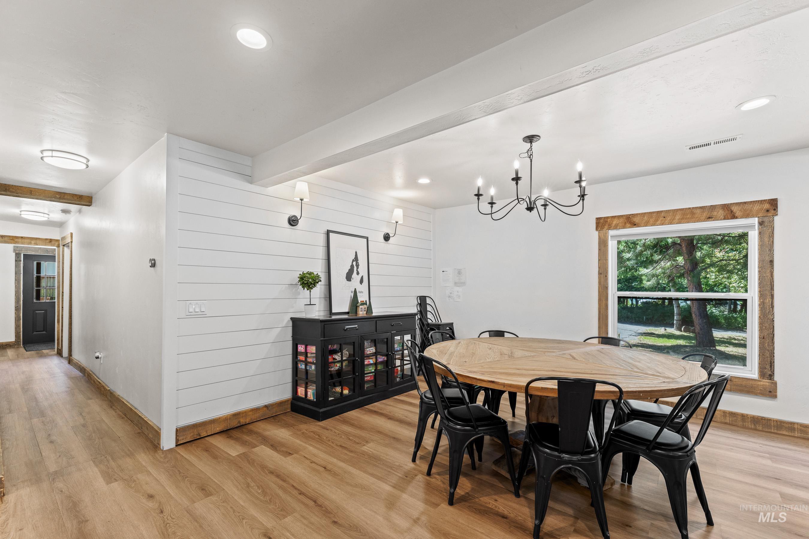 Dining room featuring light wood-style flooring, a chandelier, and recessed lighting
