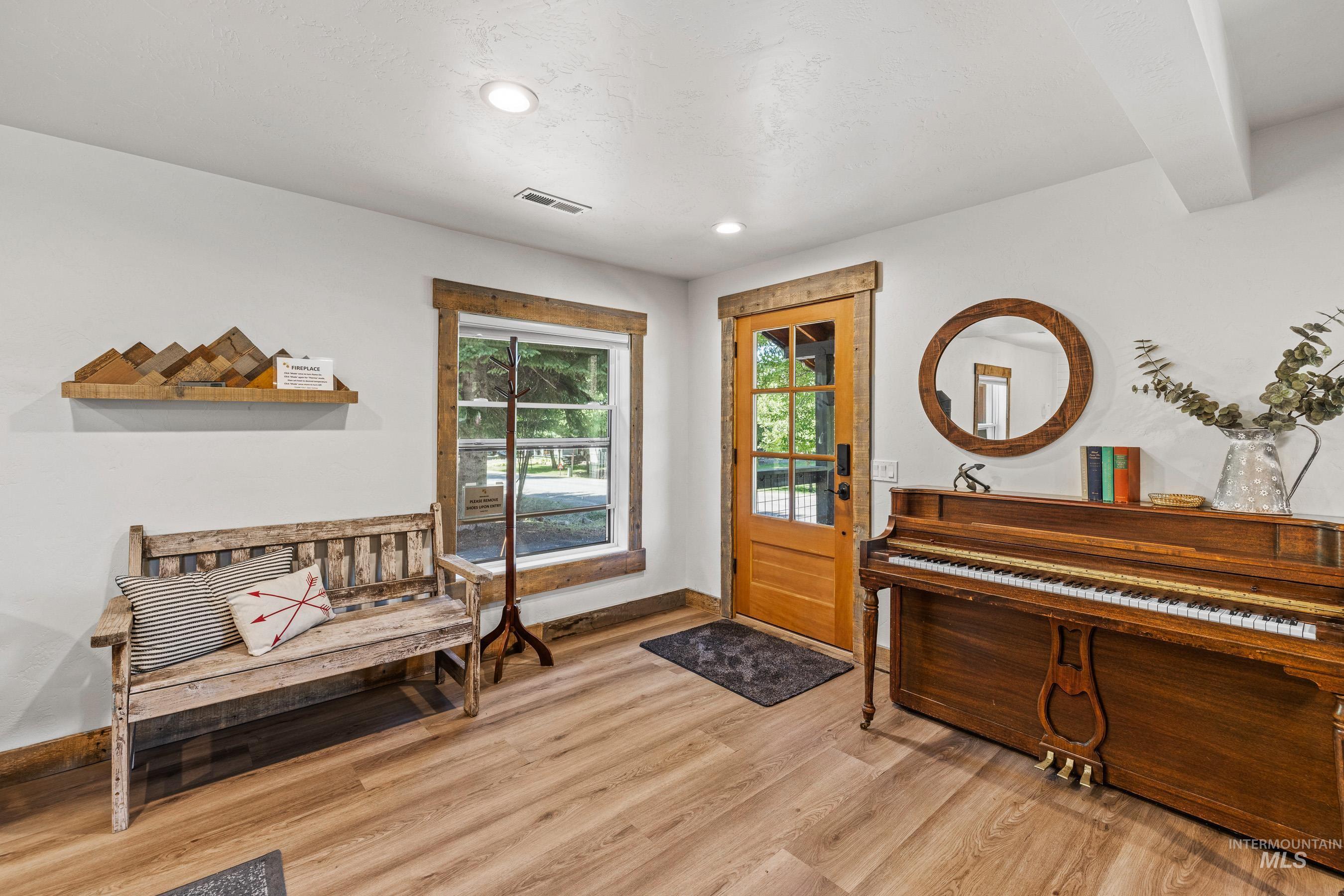 Entrance foyer with light wood-style floors and recessed lighting