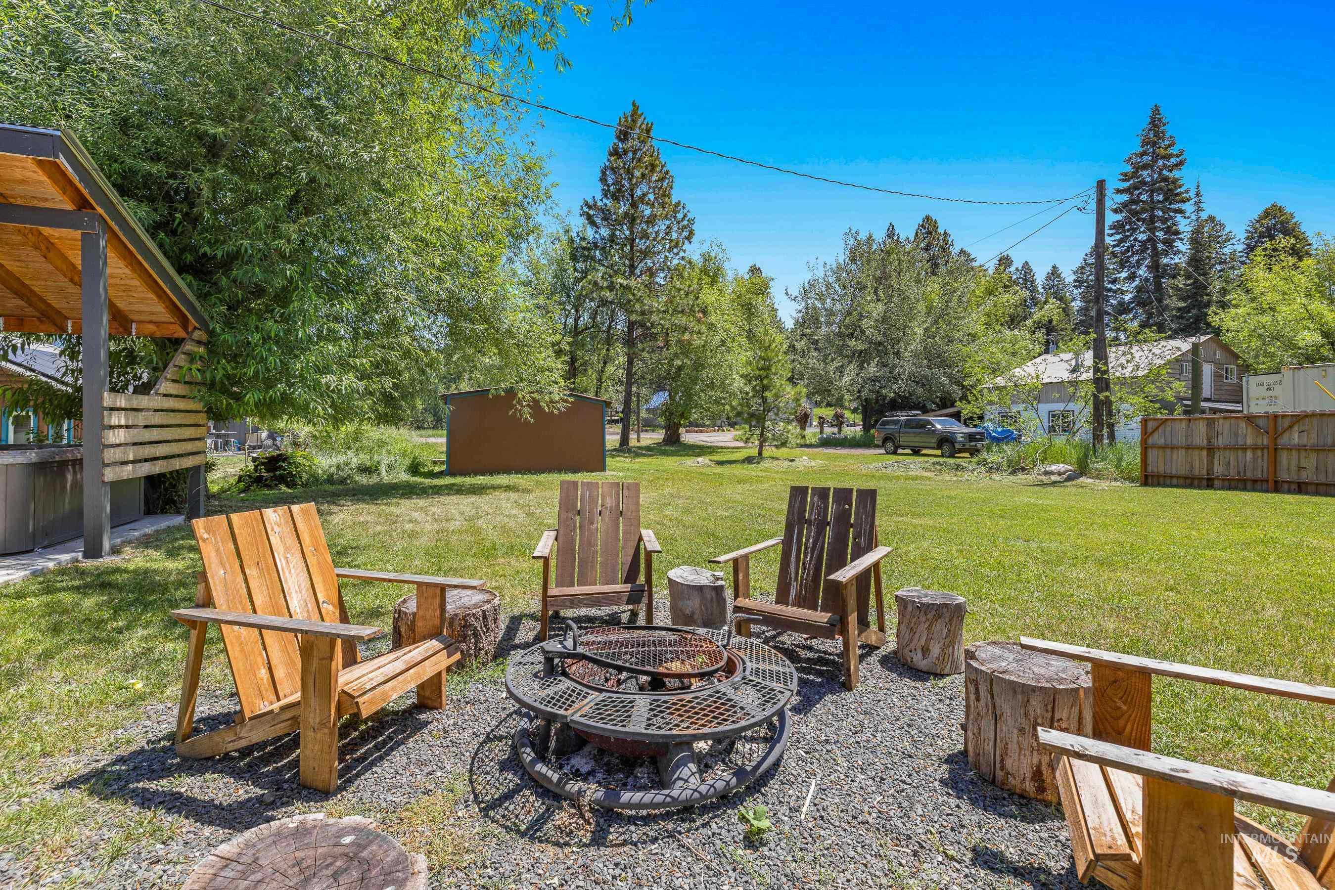 View of grassy yard featuring a fire pit