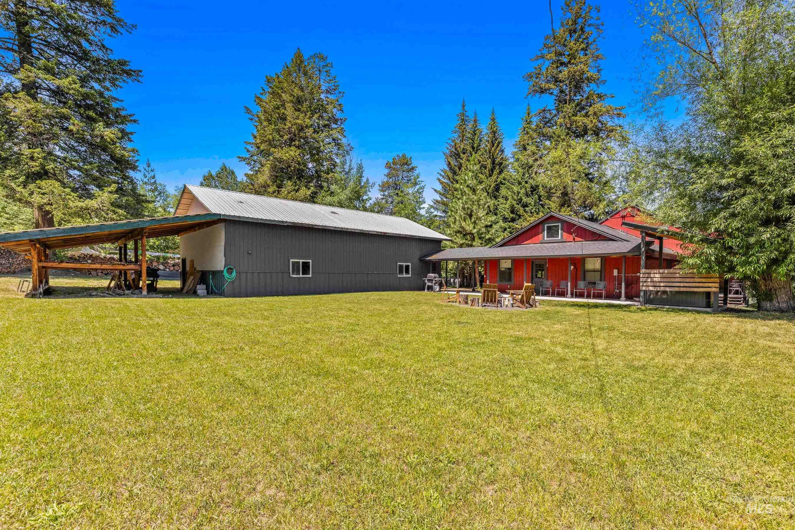 Rear view of house with a lawn and a metal roof