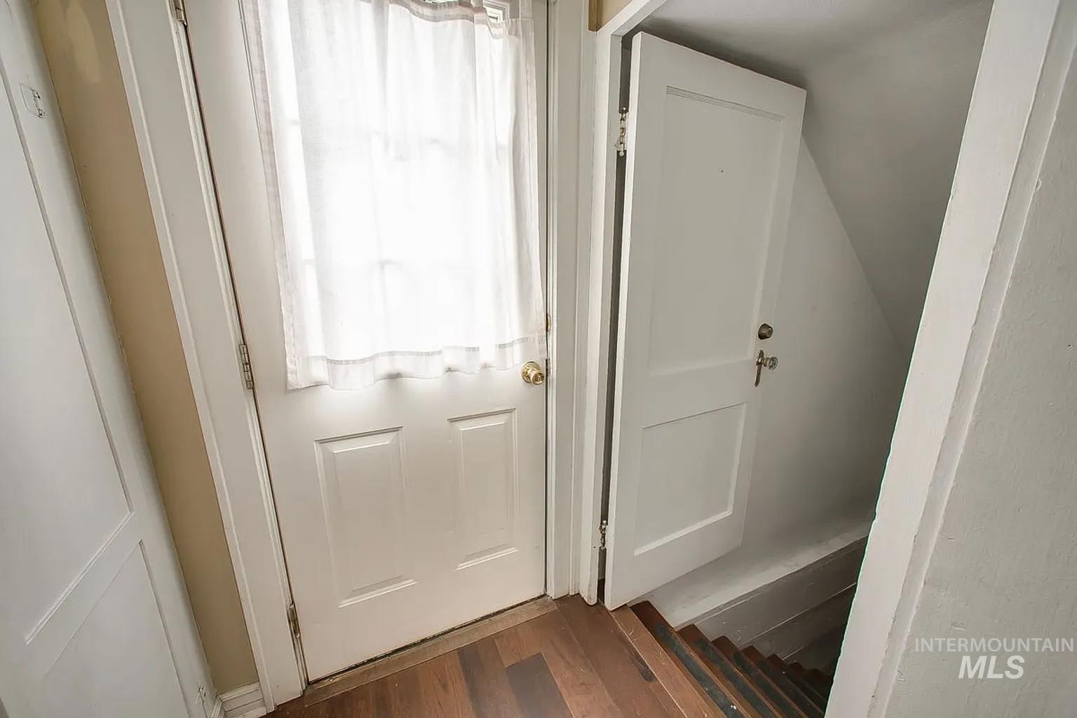 Doorway featuring wood finished floors