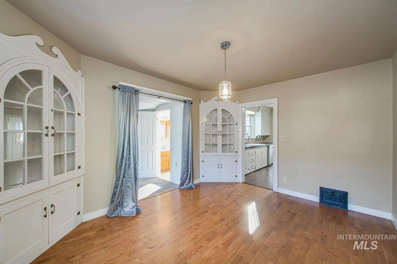 Unfurnished dining area with wood finished floors and a sink