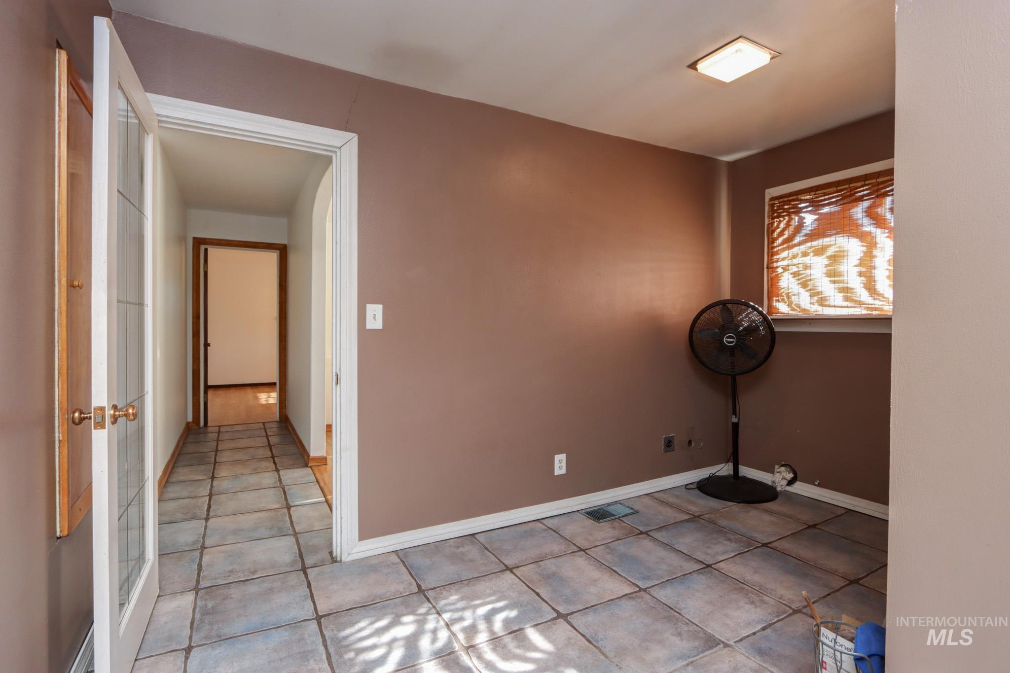 Empty room with light tile patterned floors