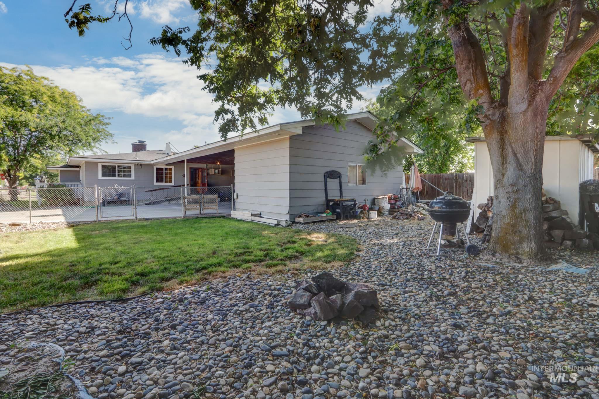 Back of property with a patio area, a gate, and a chimney