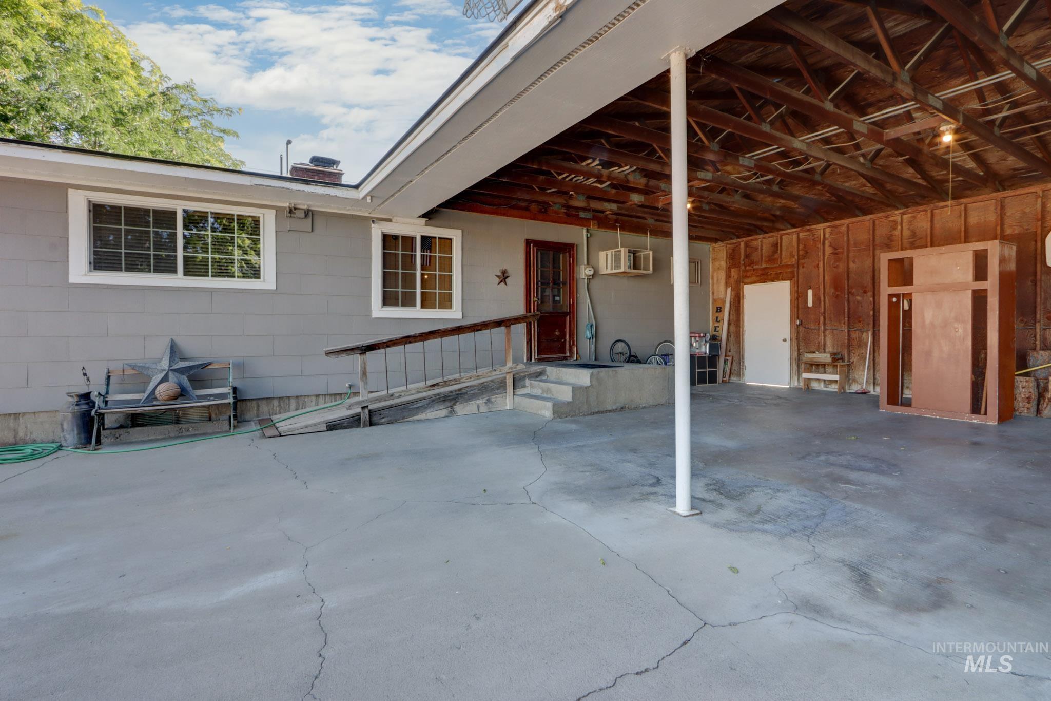 View of patio featuring a wall mounted air conditioner