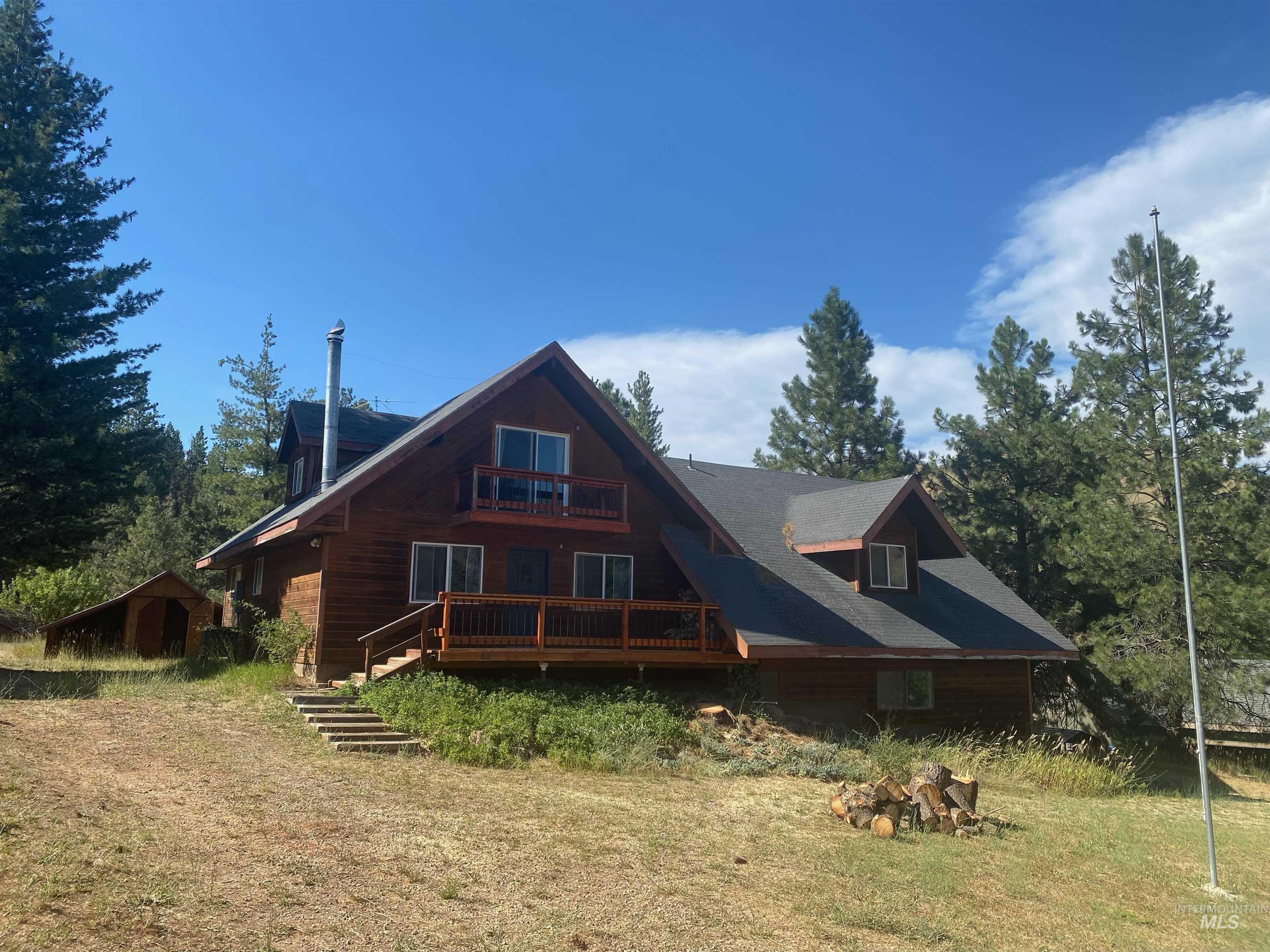 Back of property featuring a balcony and an outbuilding