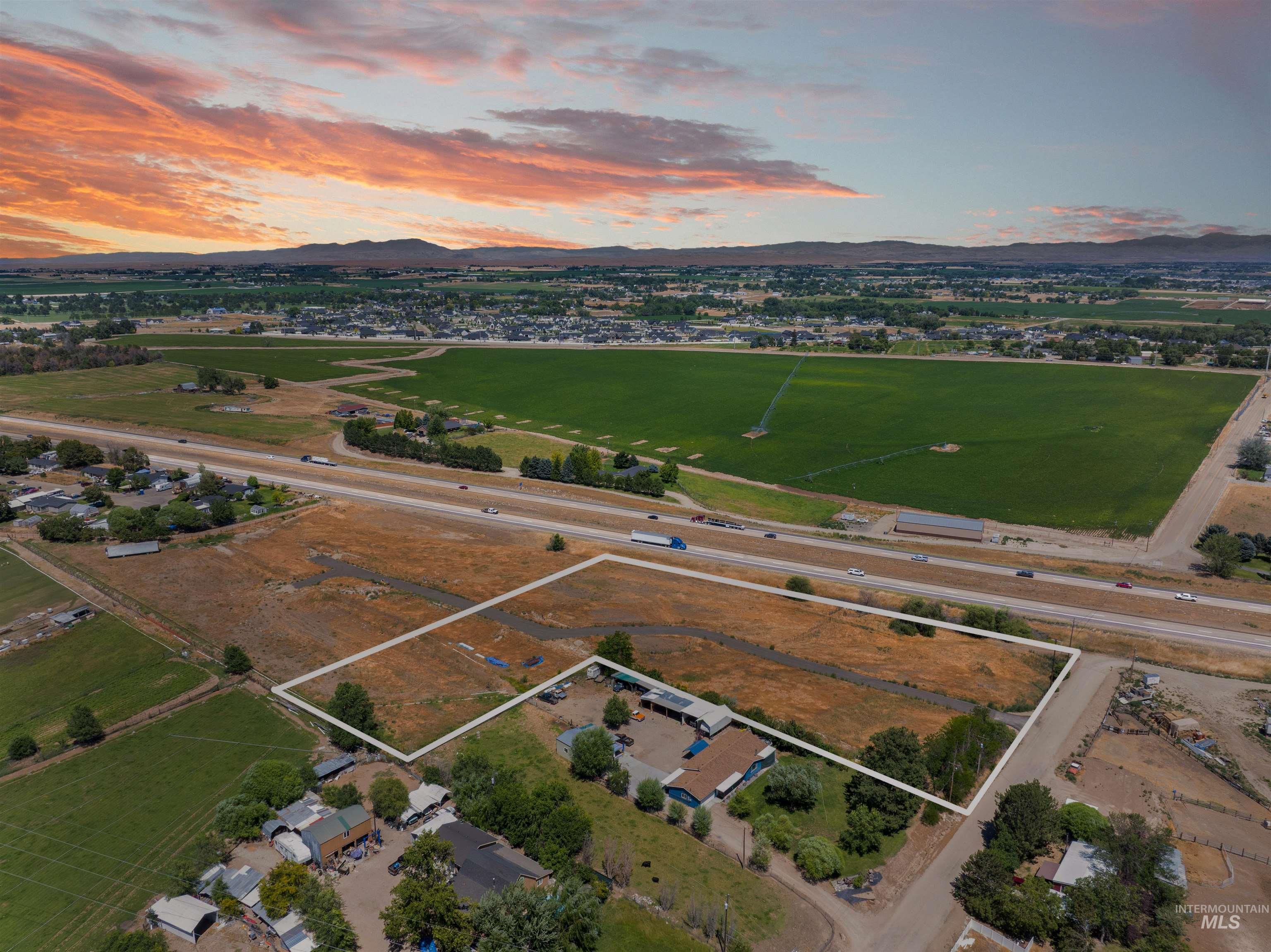 Aerial view at dusk of property boundaries highlighted and a mountain view
