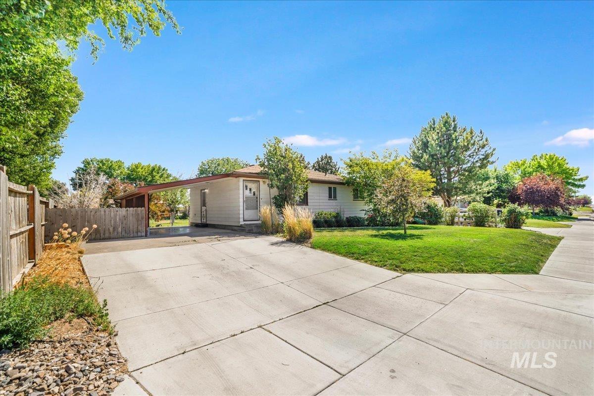 Ranch-style house with concrete driveway