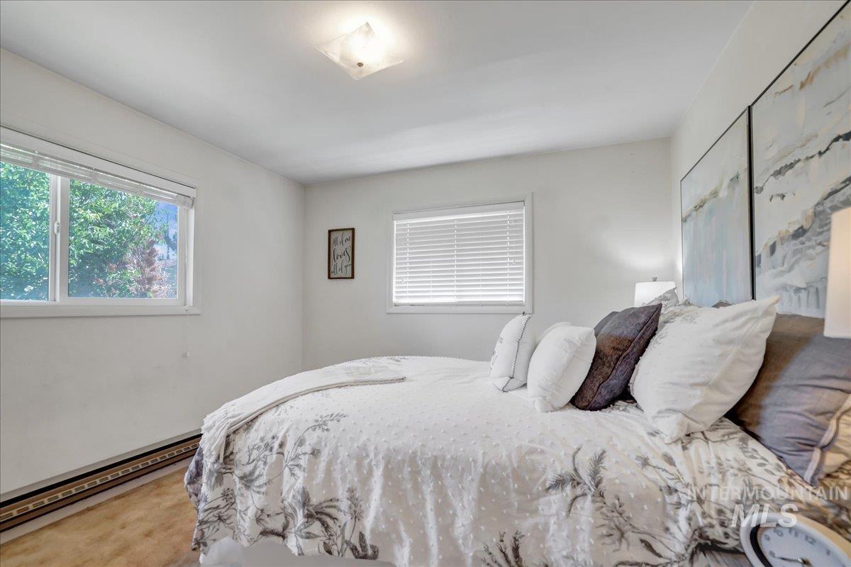 Bedroom with a baseboard heating unit
