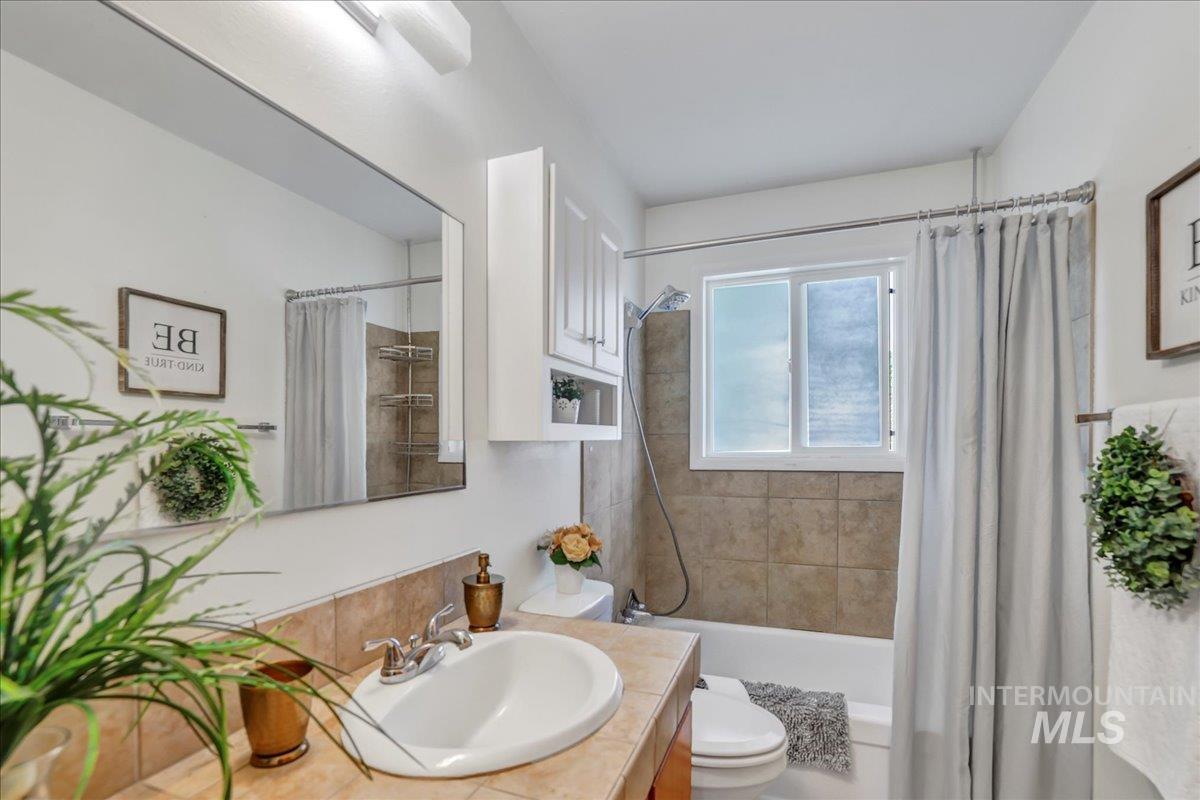 Bathroom featuring vanity and shower / bath combo