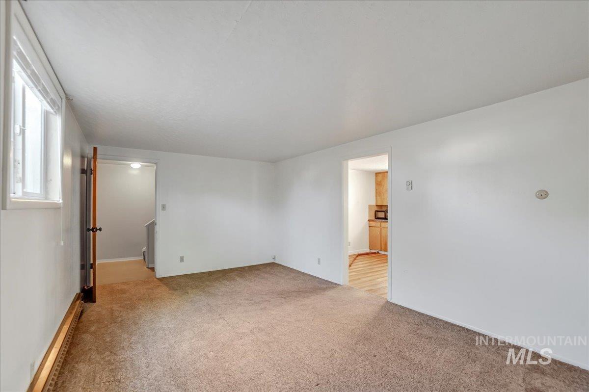 Empty room featuring light carpet