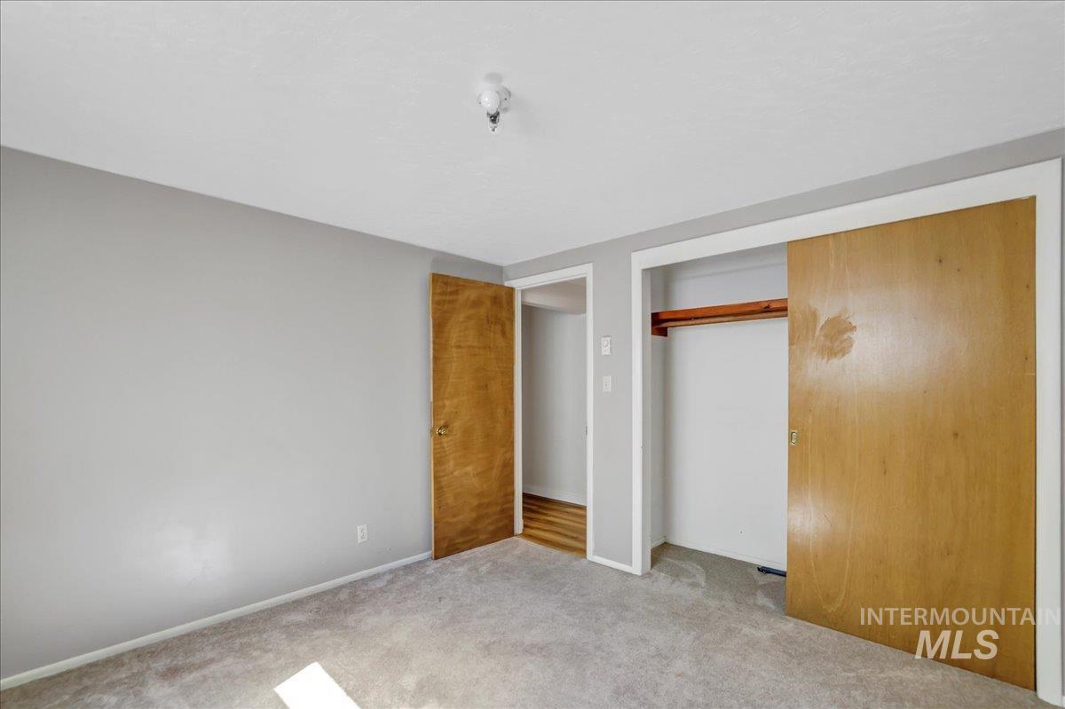 Unfurnished bedroom featuring carpet and a closet