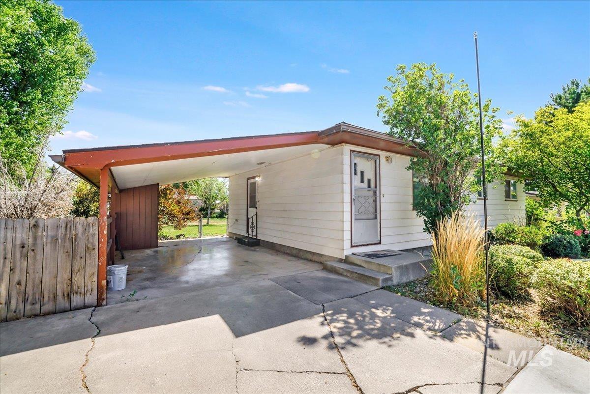View of home's exterior with driveway and a carport