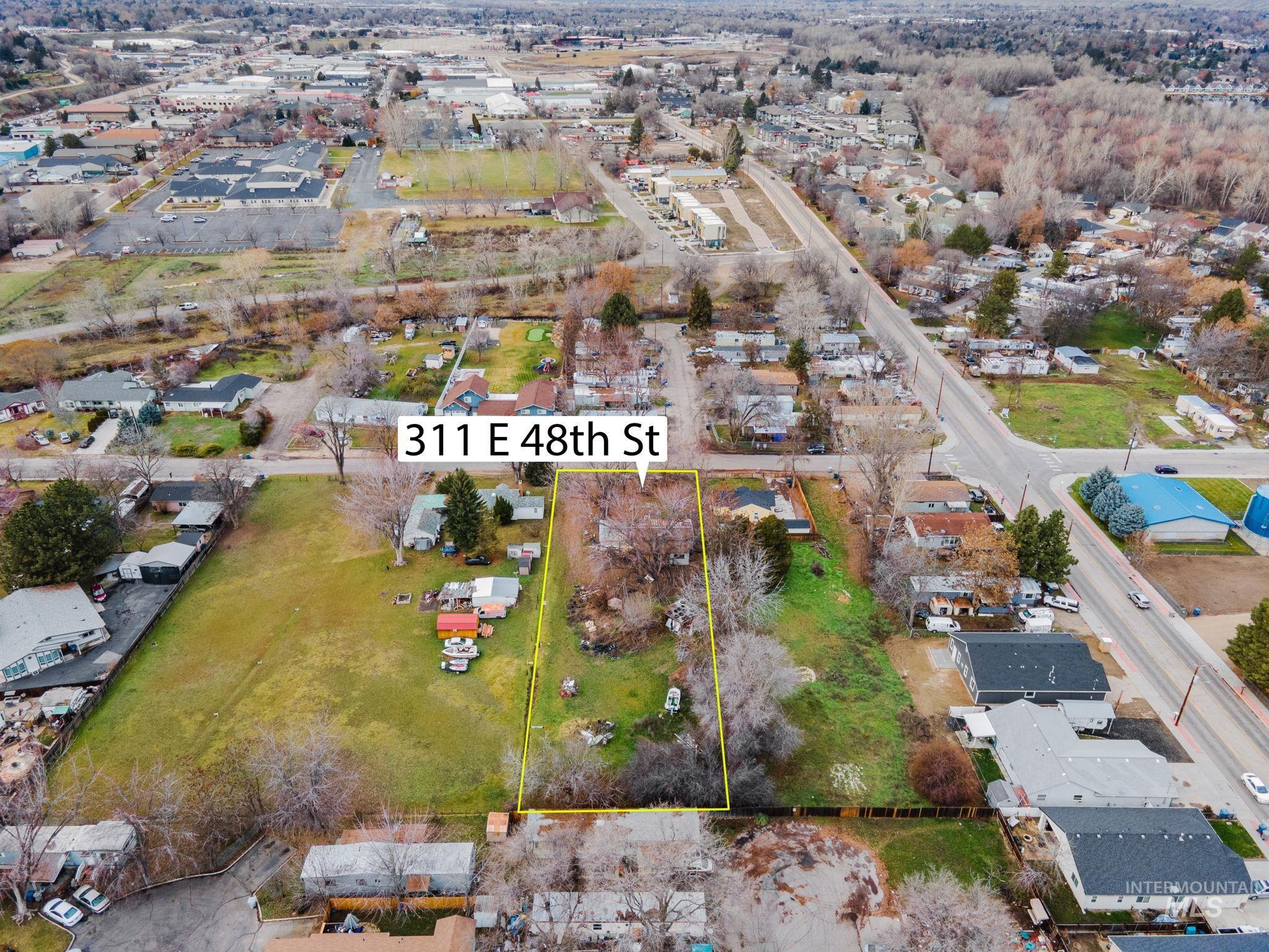 Aerial perspective of suburban area featuring property boundaries highlighted