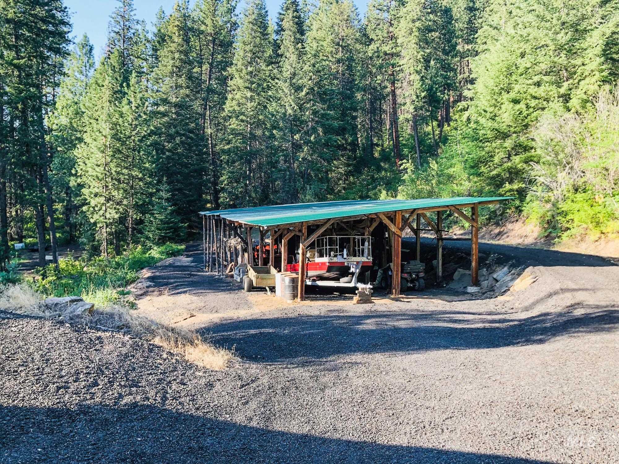 View of parking / parking lot with a wooded view