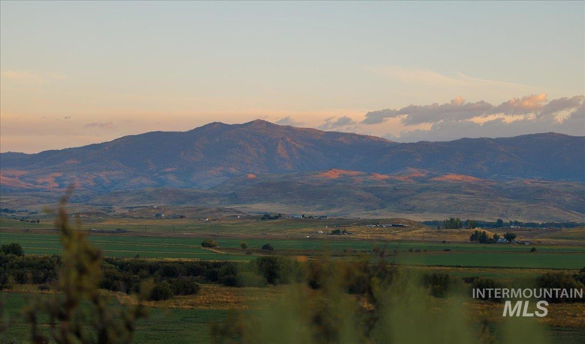 View of mountain backdrop featuring rural landscape