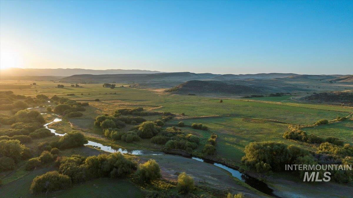 Aerial overview of property's location featuring a mountain backdrop and rural landscape