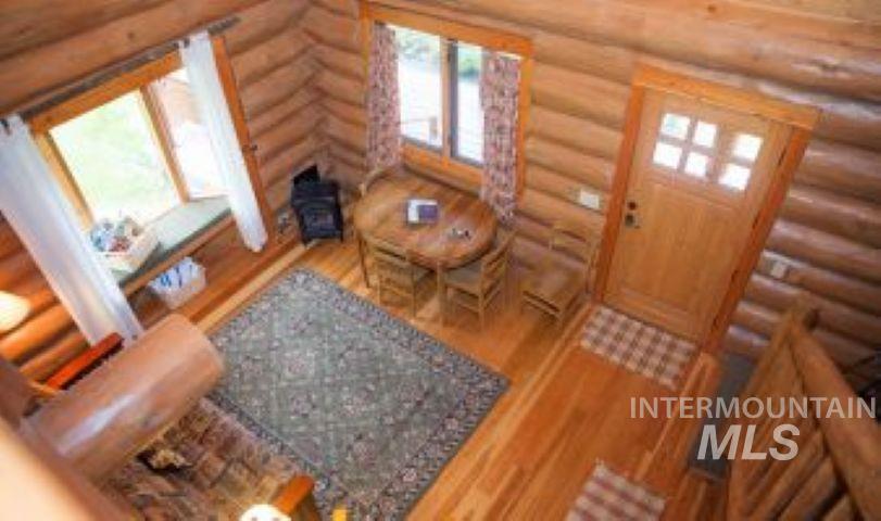 Foyer with wood finished floors and rustic walls