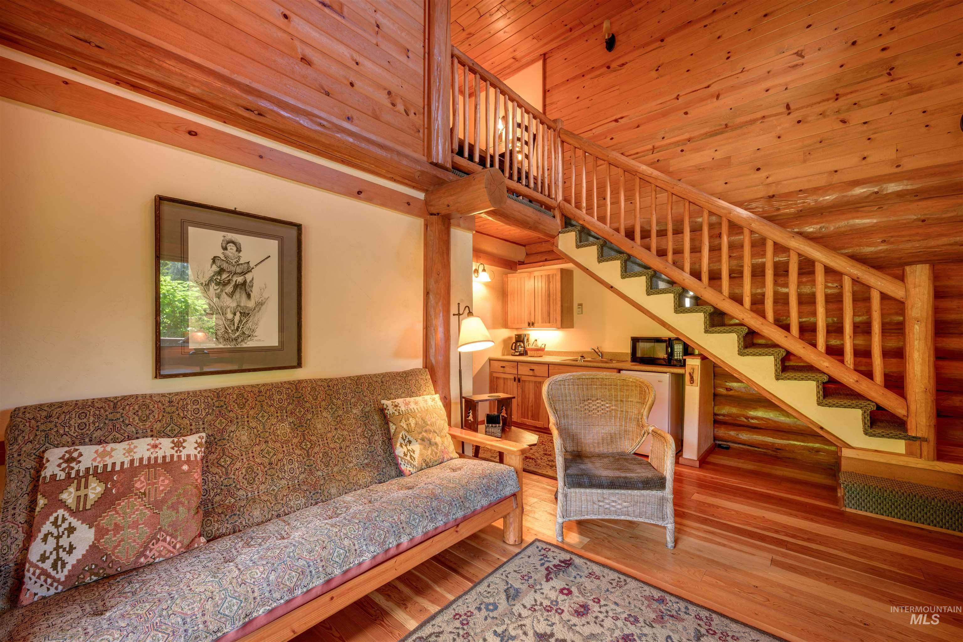 Living room featuring stairs and wood finished floors