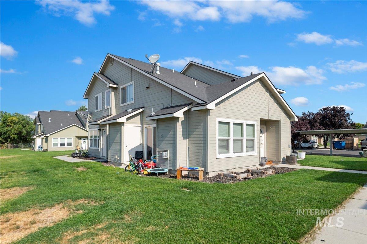 View of side of property featuring a yard