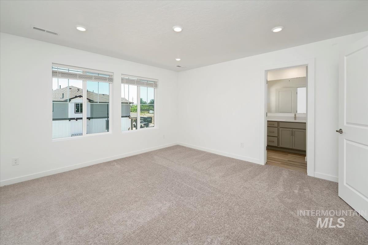 Unfurnished room with light carpet and recessed lighting
