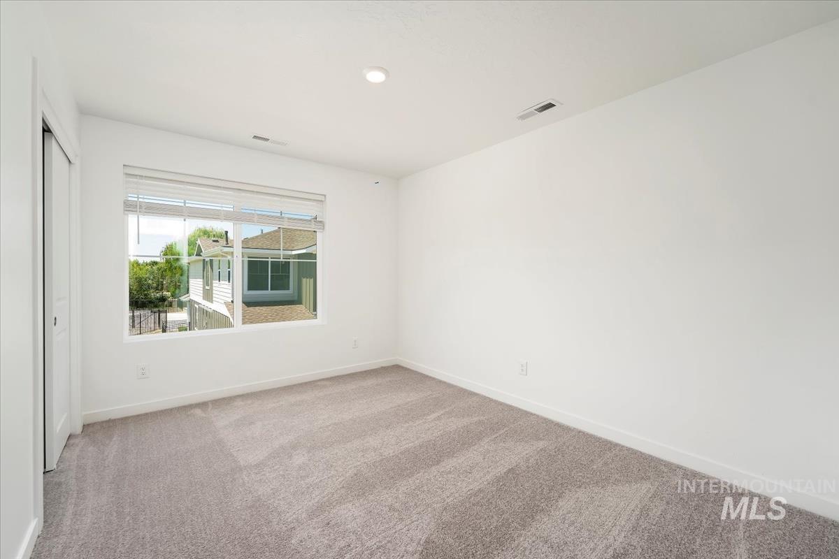 Empty room featuring carpet flooring and recessed lighting