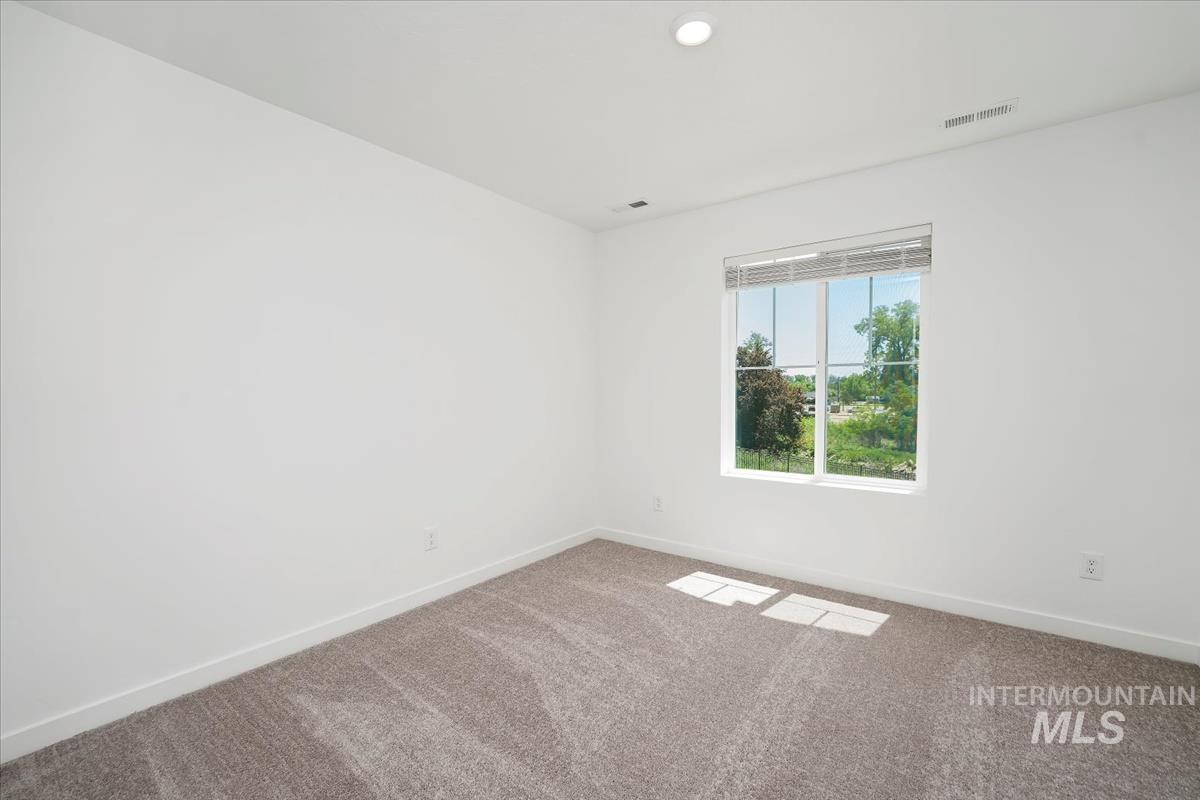 Empty room featuring carpet and recessed lighting