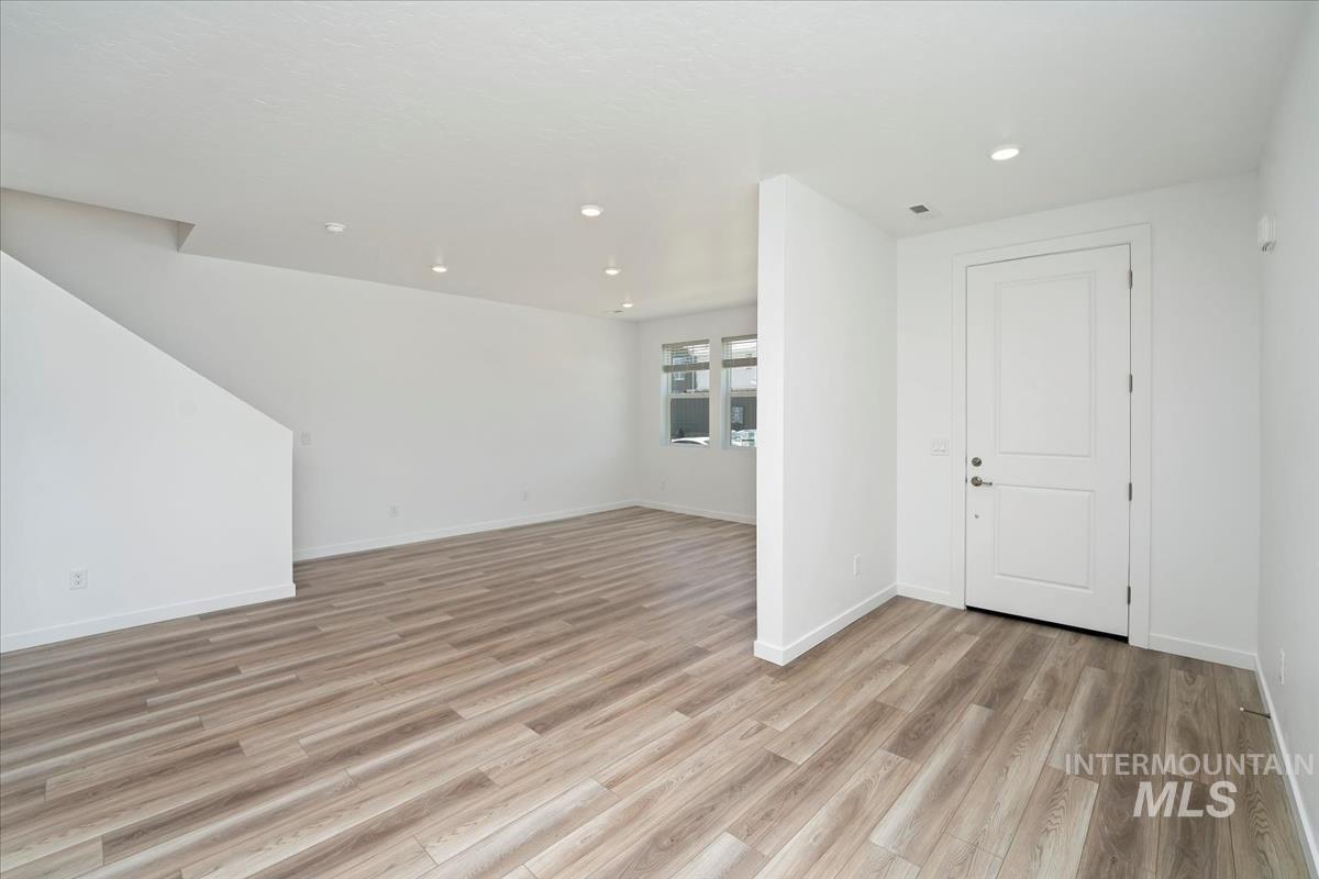 Unfurnished living room featuring light wood-style floors and recessed lighting
