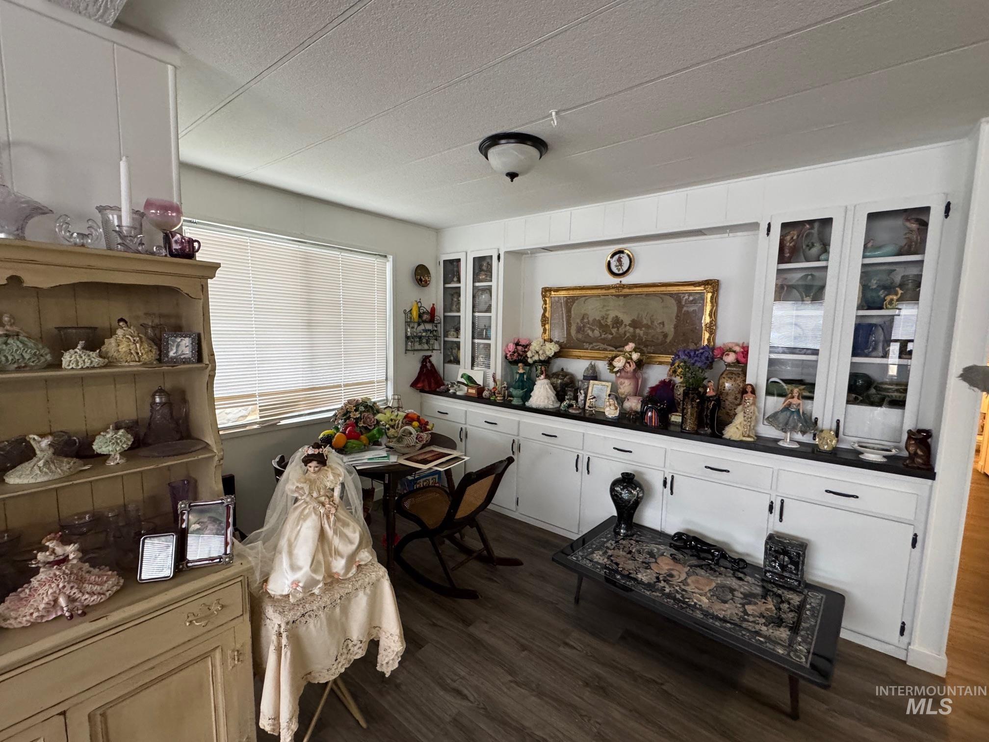 Dining area featuring a textured ceiling and dark wood finished floors