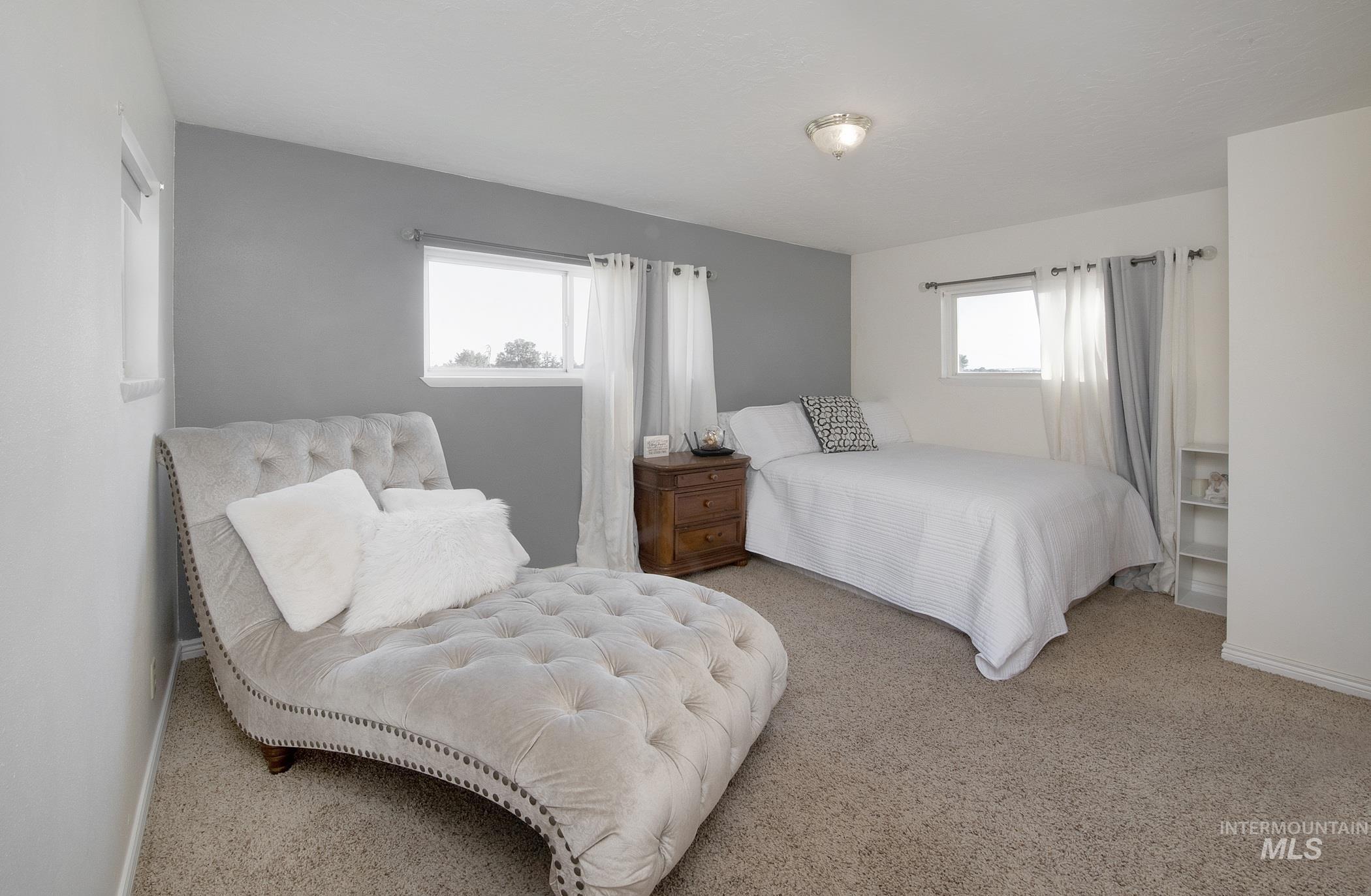 Carpeted bedroom featuring baseboards