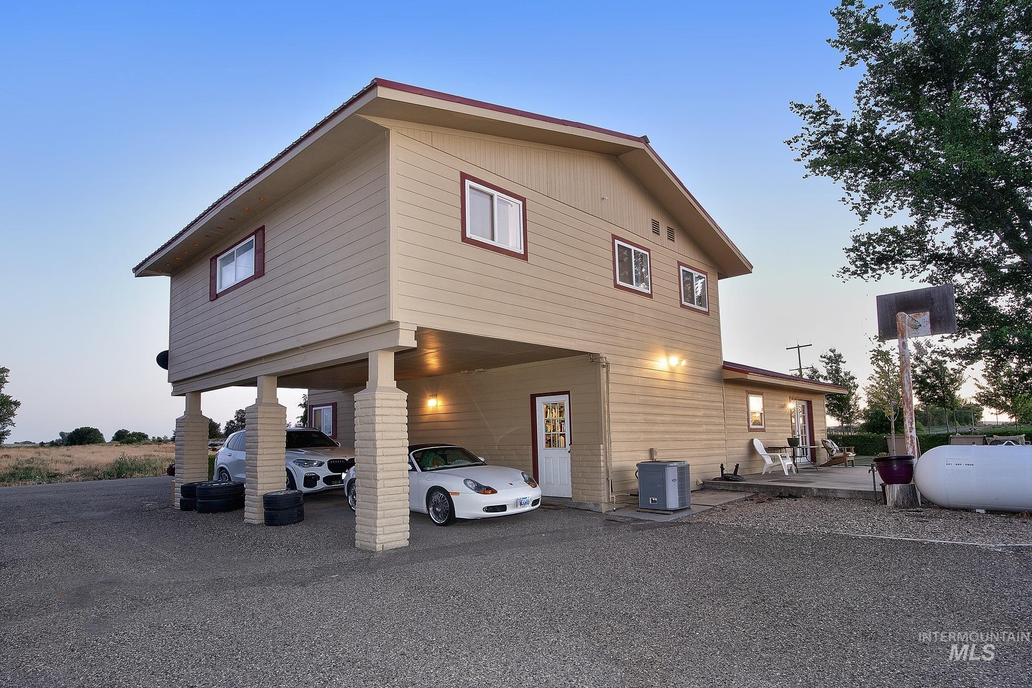 View of property exterior featuring a carport and driveway