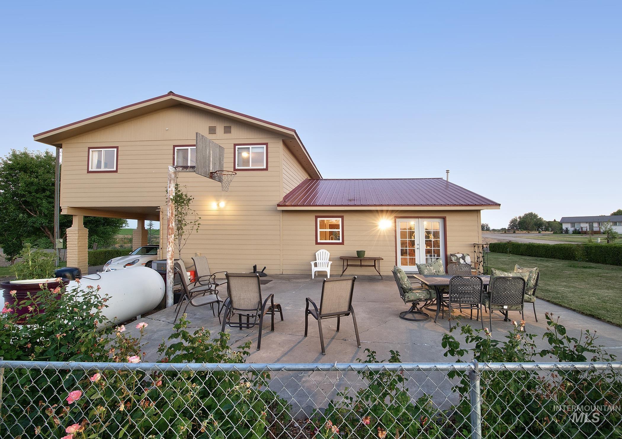 Back of house featuring a metal roof, a patio, and french doors