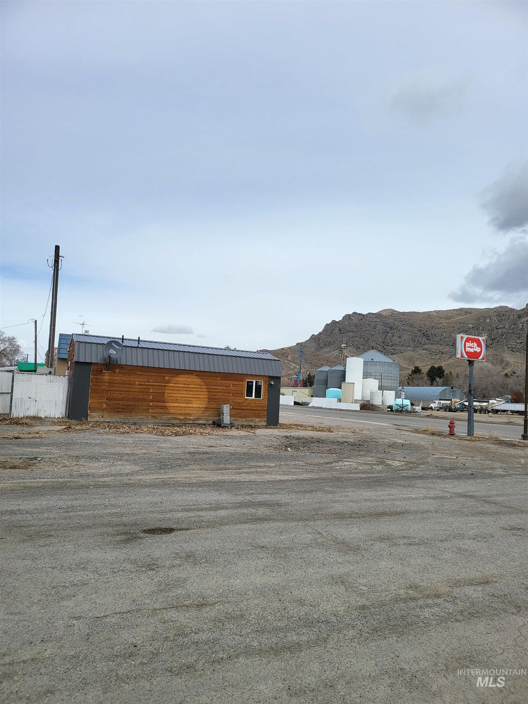 View of asphalt road featuring traffic signs and a mountain view